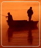 Two men fishing at sunset